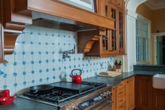 American Colonial Style Tile Backsplash With Traditional Style Cabinets & Stove Top - Colorado Springs Renovation