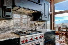 Mountain Home Kitchen Design - Black Kitchen Cabinets With Granite Backsplash